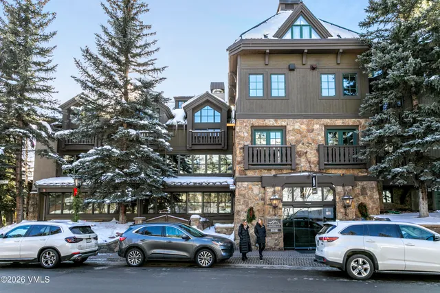 a bedroom with two beds and a mirror