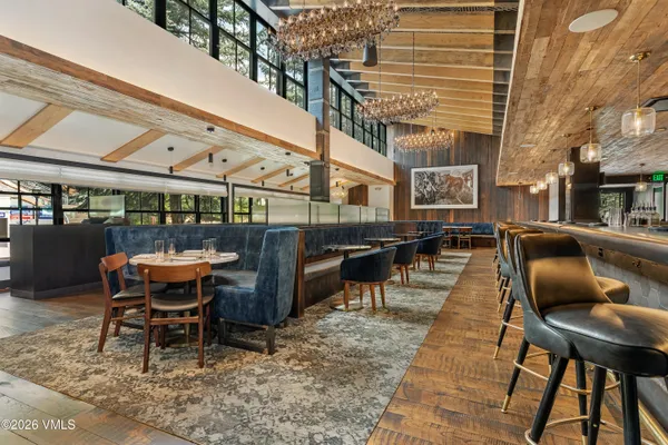 a roof deck with table and chairs