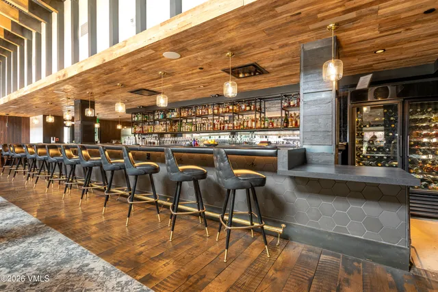 a living room with couches and a dining table with garden view