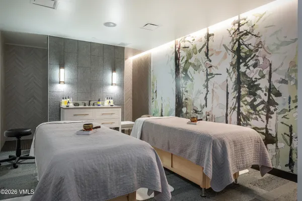 a bedroom with two beds and a mirror