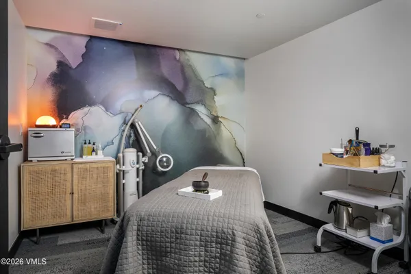 a living room with couches and a dining table with garden view