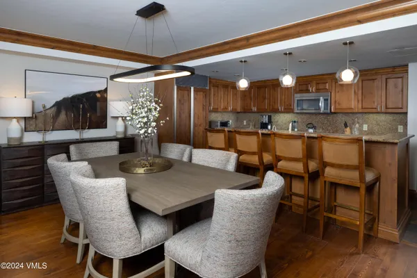 a view of a dining room with furniture and wooden floor