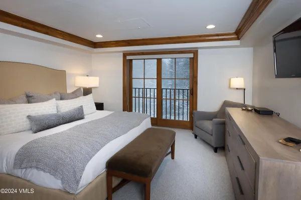 a bedroom with a bed couch and a window