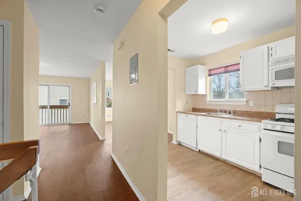 a view of hallway with furniture and a window