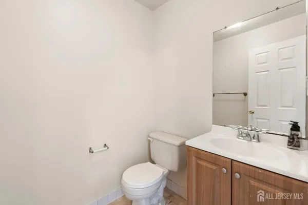 a bathroom with a sink toilet and a mirror