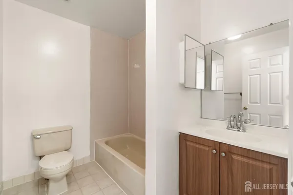 a bathroom with a sink toilet vanity and bathtub