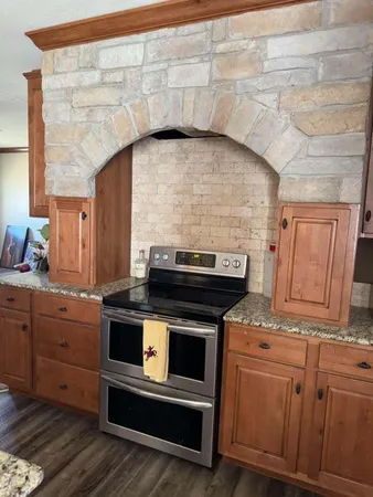 a stove top oven sitting inside of a kitchen
