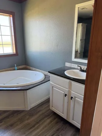 a kitchen with cabinets and a window