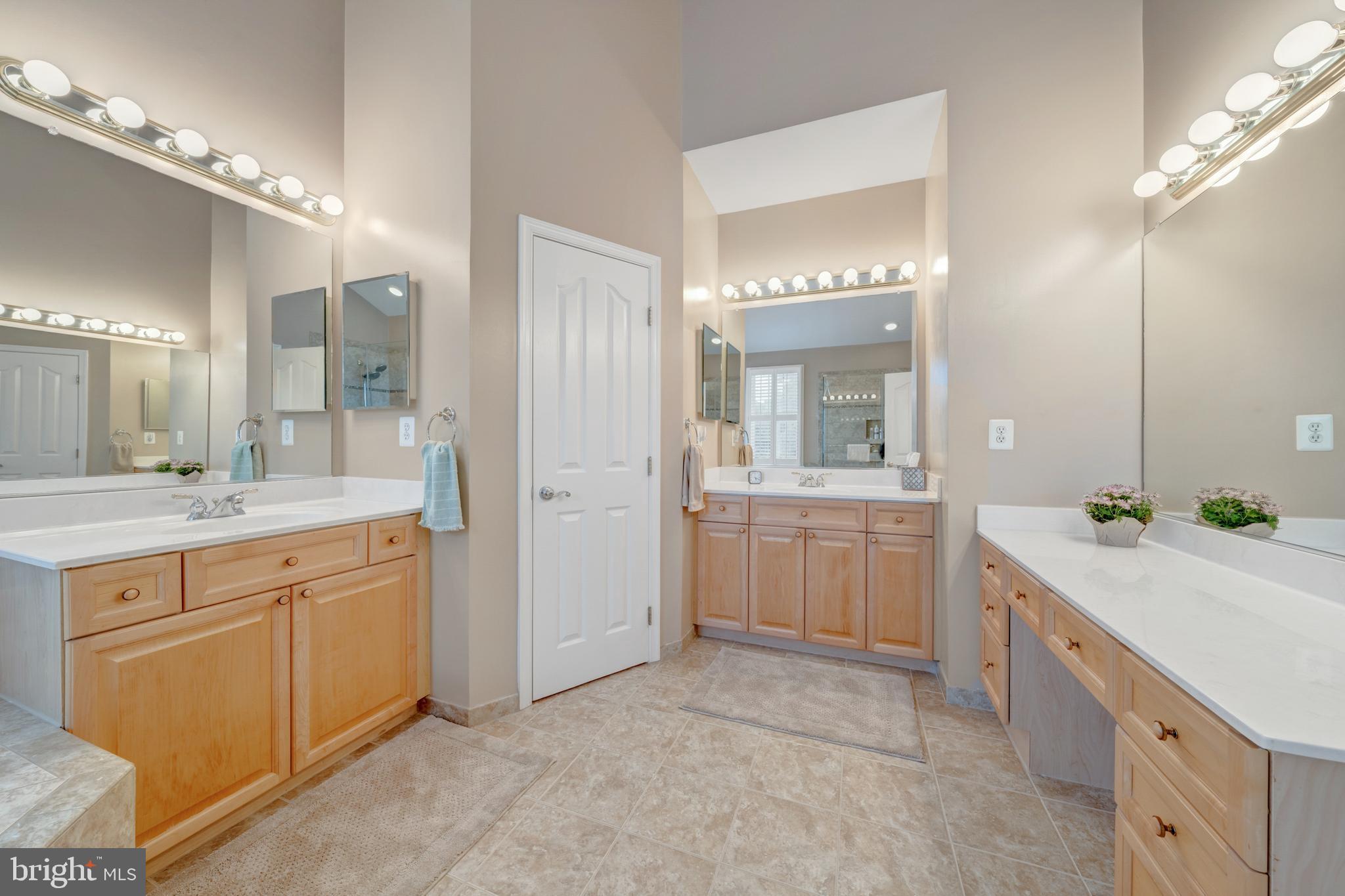 1925 Logan Manor Drive Reston, VA 20190 - Photo 24 of 61 a spacious bathroom with a granite countertop sink a mirror a shower and a mirror