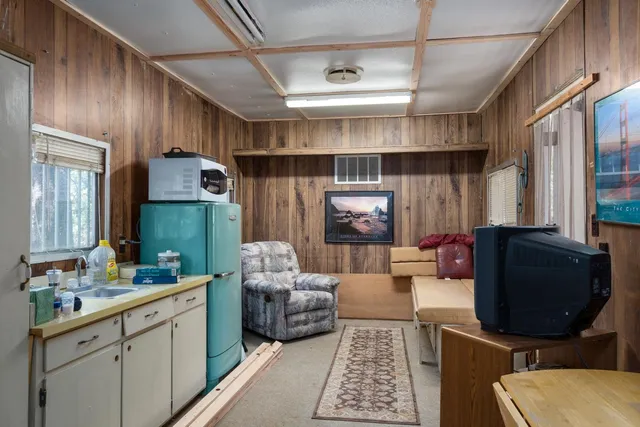 a kitchen with stainless steel appliances a refrigerator and a stove top oven