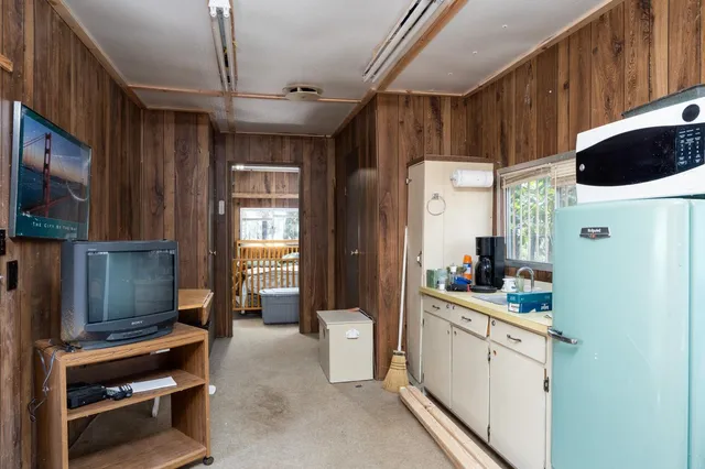 a aerial view of a house with a yard and large trees