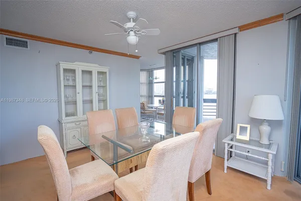 a dining room with furniture and a window