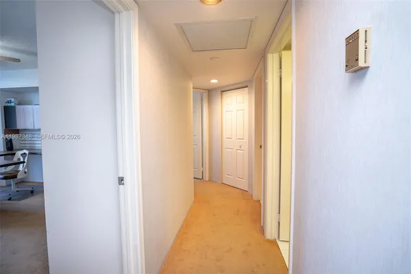 a view of a hallway with furniture and entryway