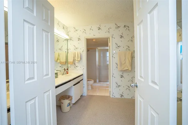 a bathroom with a double vanity sink mirror double and shower