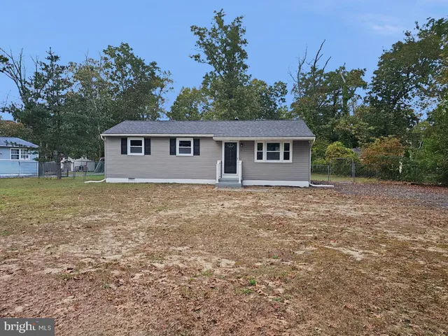 a view of house with backyard
