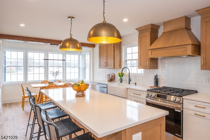 43 East Shore Road Denville, NJ 07834 - Photo 11 of 45 a kitchen with a stove a kitchen island a dining table and chairs