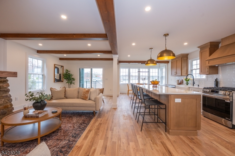 43 East Shore Road Denville, NJ 07834 - Photo 14 of 45 a living room with furniture a large window and wooden floors