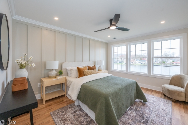 43 East Shore Road Denville, NJ 07834 - Photo 21 of 45 a spacious bedroom with a bed a couch and a window