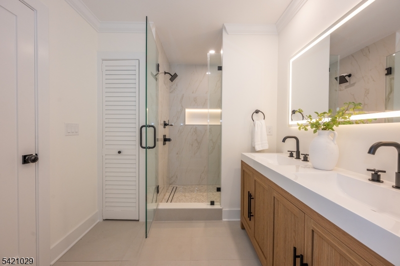 43 East Shore Road Denville, NJ 07834 - Photo 25 of 45 a bathroom with a double vanity sink mirror and shower