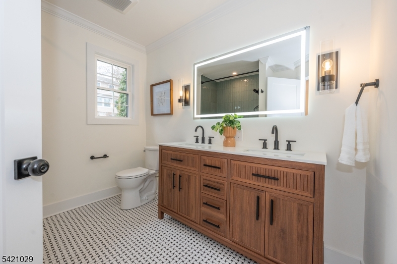 43 East Shore Road Denville, NJ 07834 - Photo 28 of 45 a spacious bathroom with a mirror sink and toilet
