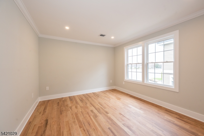 43 East Shore Road Denville, NJ 07834 - Photo 31 of 45 an empty room with wooden floor and windows