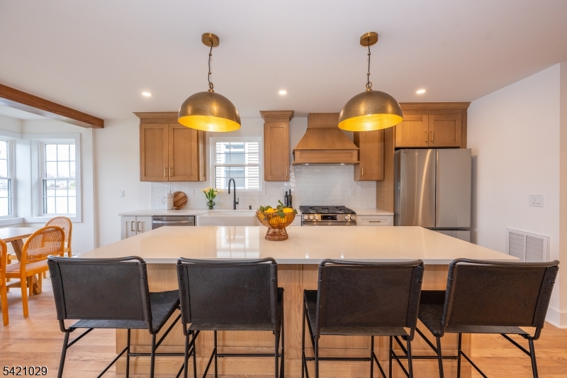 43 East Shore Road Denville, NJ 07834 - Photo 10 of 45 a kitchen with stainless steel appliances a table chairs and a refrigerator