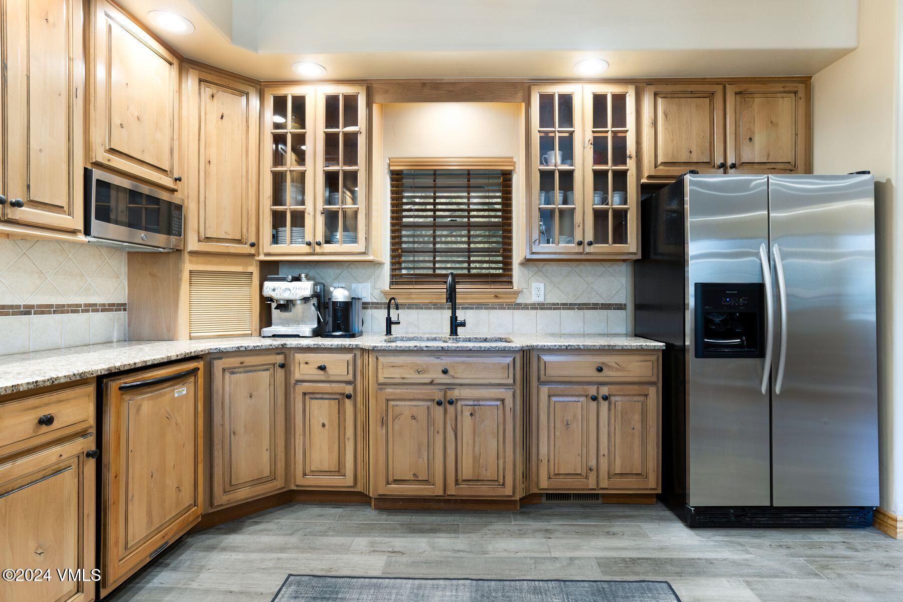 39555 Highway 6, Unit E Avon, CO 81620 - Photo 15 of 42 a kitchen with stainless steel appliances granite countertop a refrigerator and a sink