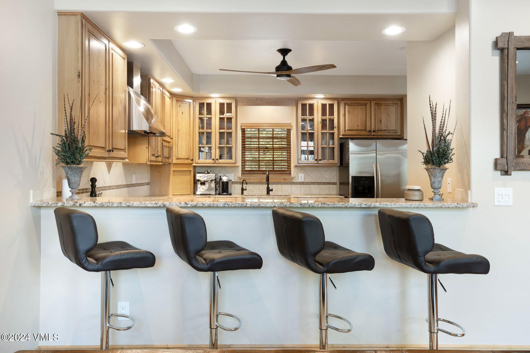 39555 Highway 6, Unit E Avon, CO 81620 - Photo 16 of 42 a kitchen with a dining table chairs sink and cabinets