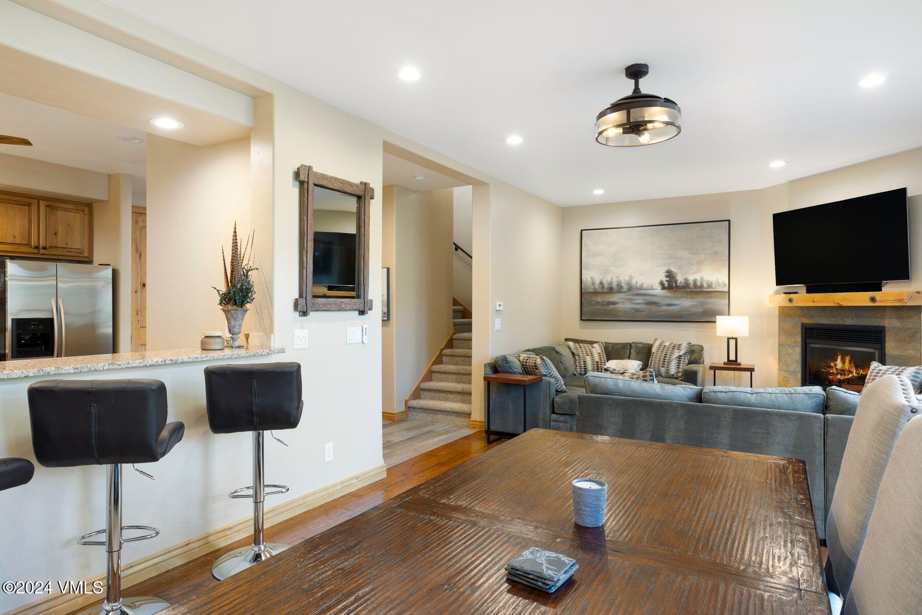 39555 Highway 6, Unit E Avon, CO 81620 - Photo 19 of 42 a living room with fireplace furniture and a flat screen tv