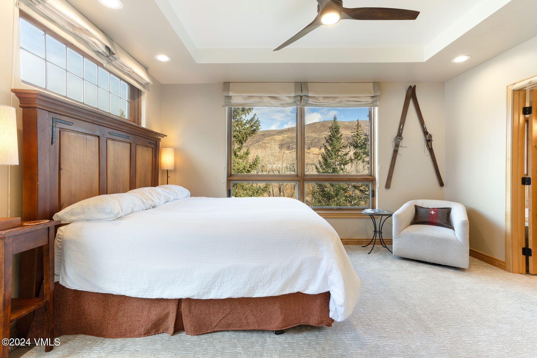 39555 Highway 6, Unit E Avon, CO 81620 - Photo 24 of 42 a bedroom with a bed couch and a large window
