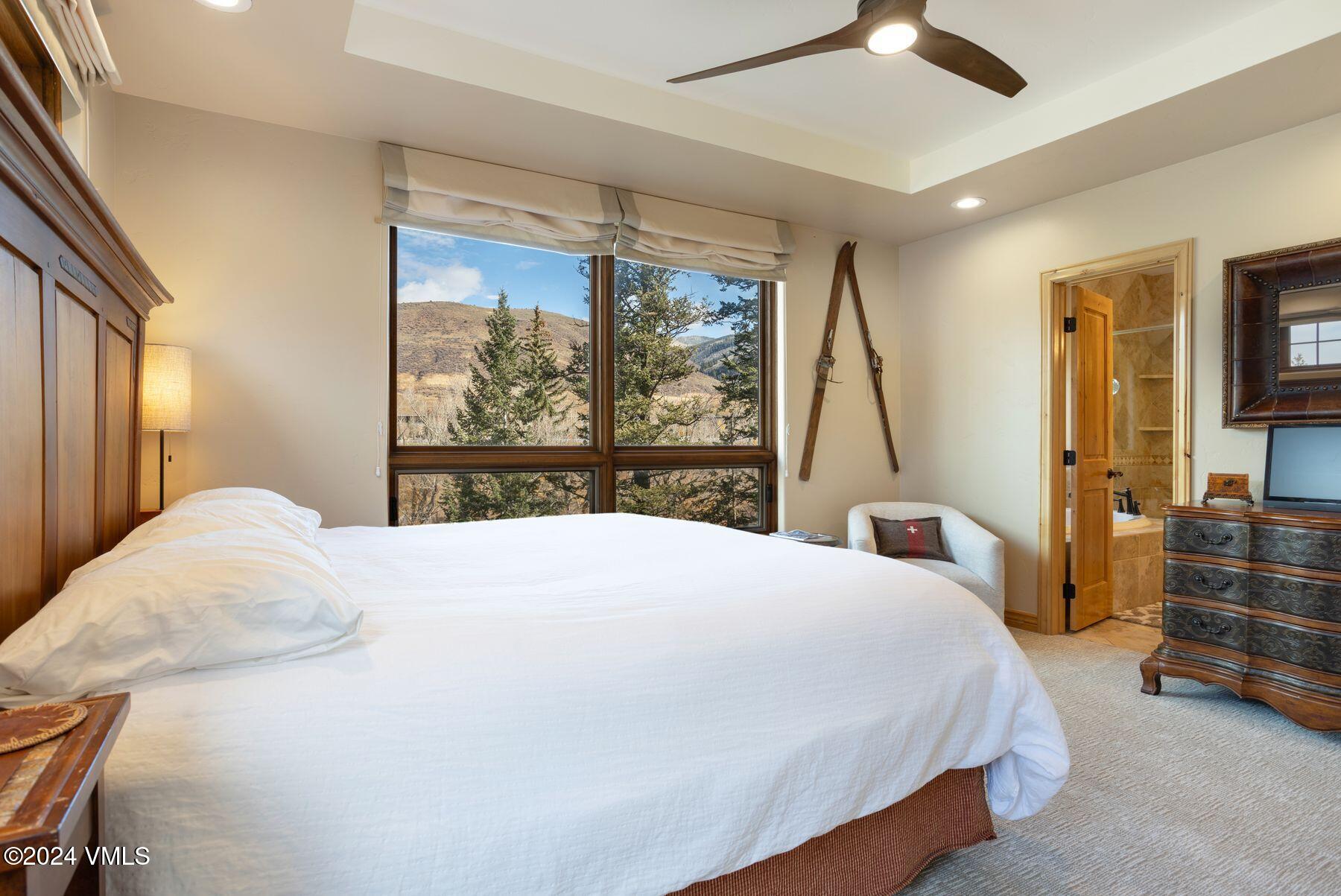 39555 Highway 6, Unit E Avon, CO 81620 - Photo 25 of 42 a bedroom with a large bed and a large window