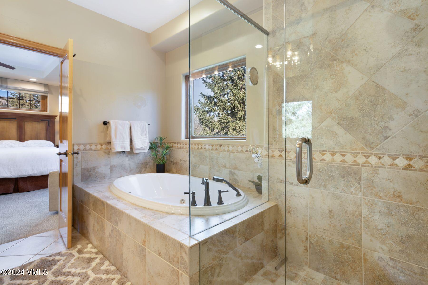 39555 Highway 6, Unit E Avon, CO 81620 - Photo 27 of 42 a bathroom with a tub a sink and a shower