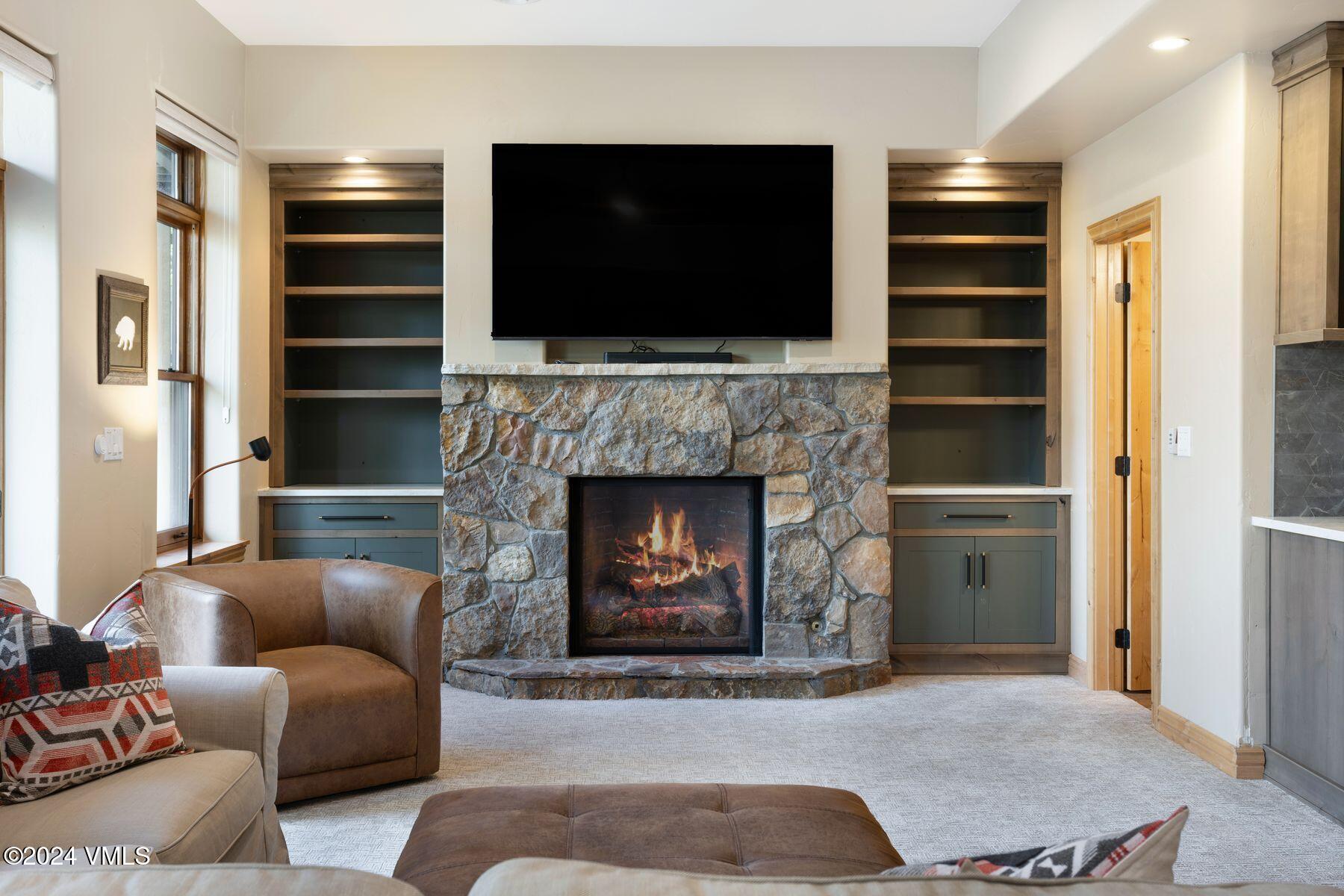 39555 Highway 6, Unit E Avon, CO 81620 - Photo 28 of 42 a living room with furniture a flat screen tv and a fireplace