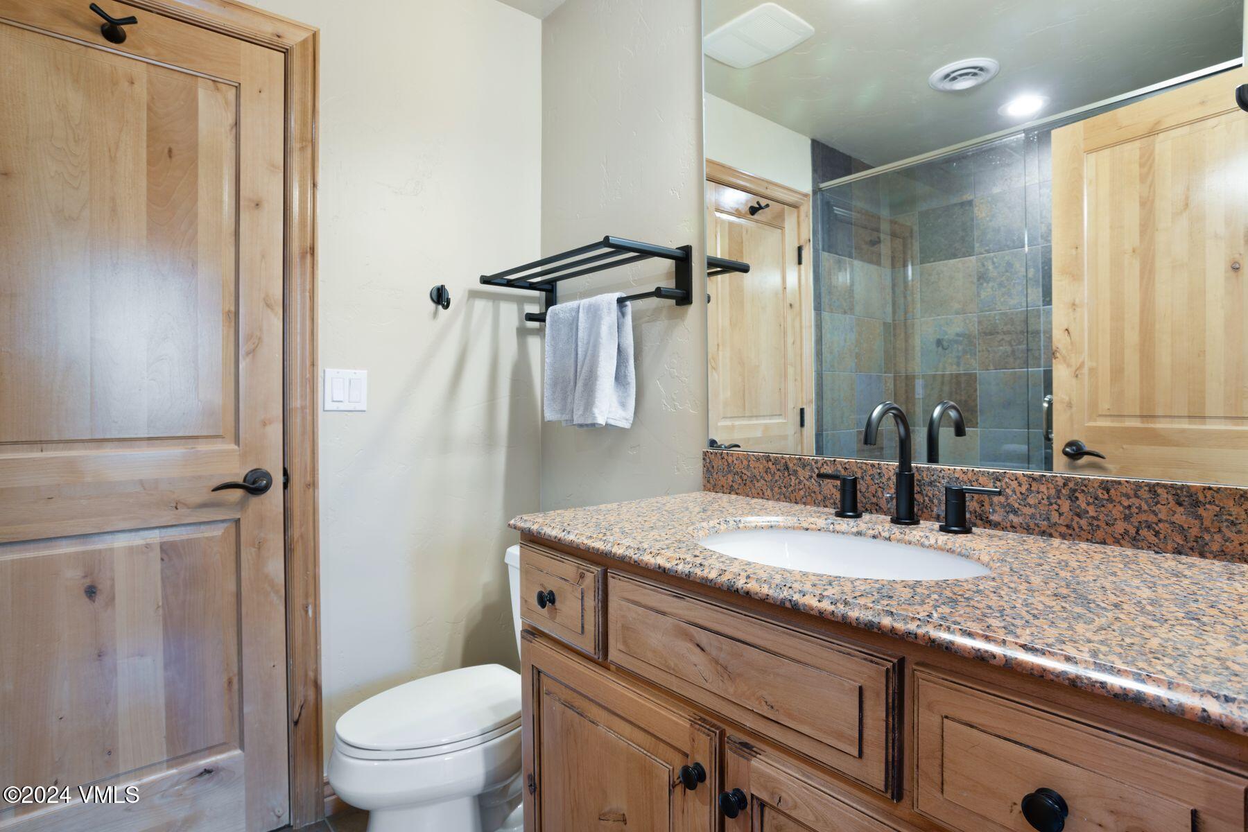 39555 Highway 6, Unit E Avon, CO 81620 - Photo 31 of 42 a bathroom with a granite countertop sink toilet and shower