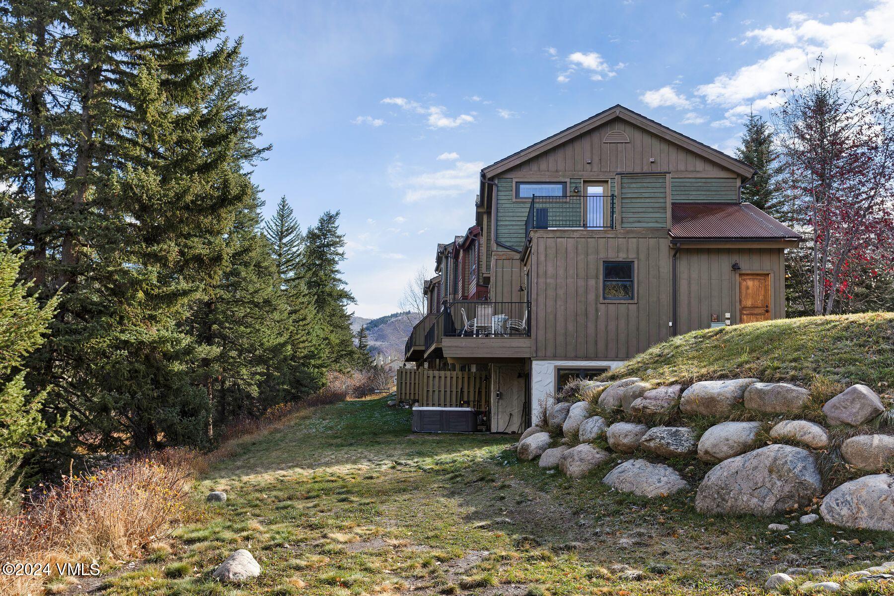 39555 Highway 6, Unit E Avon, CO 81620 - Photo 36 of 42 a view of a house with wooden fence and large trees