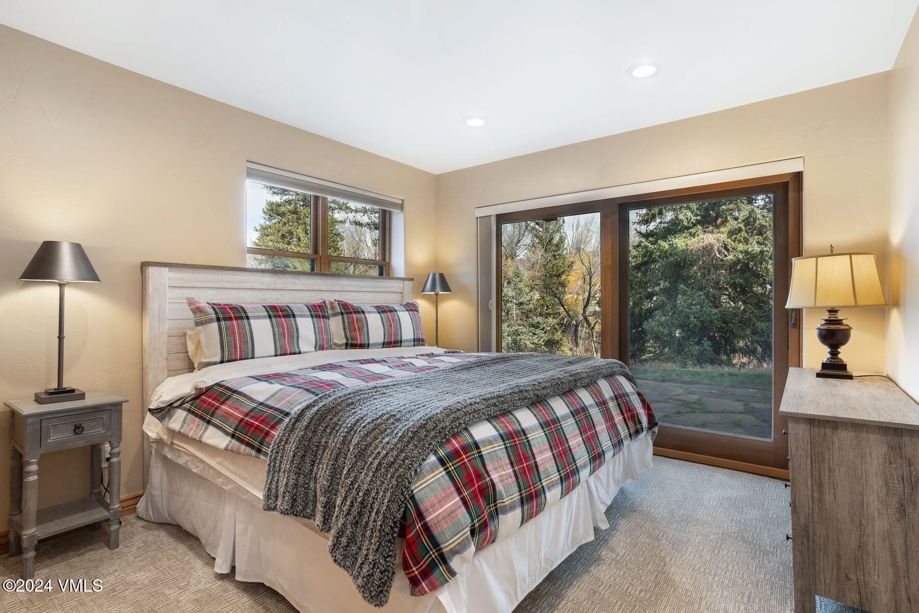 39555 Highway 6, Unit E Avon, CO 81620 - Photo 9 of 42 a bedroom with a large bed and a large window
