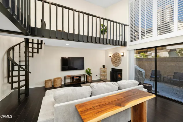a living room with furniture fireplace and flat screen tv