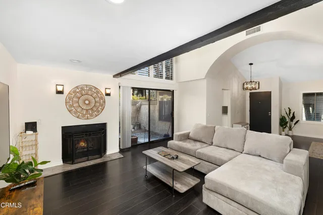 a living room with furniture a fireplace and a fireplace