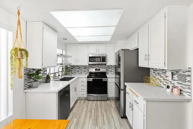 a kitchen with a sink stove and refrigerator