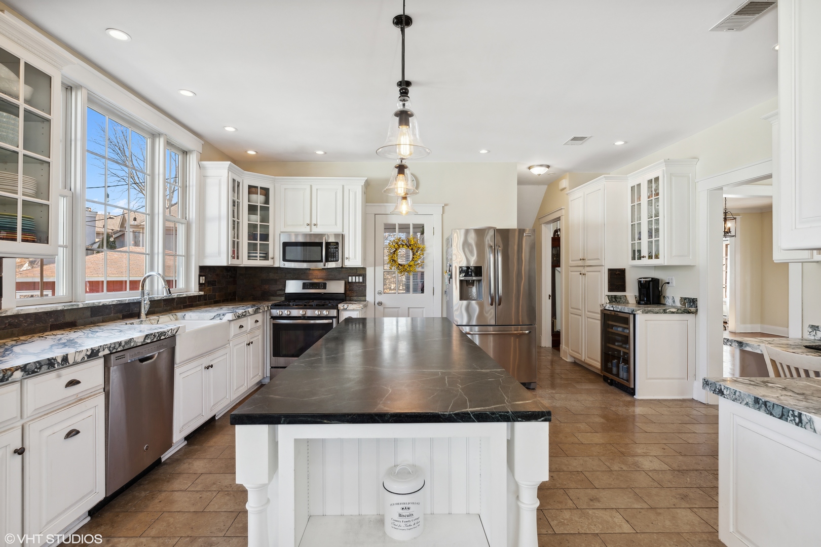 17859 Howe Avenue Homewood, IL 60430 - Photo 4 of 25 a kitchen with stainless steel appliances granite countertop a refrigerator a stove top oven a sink a dining table and chairs