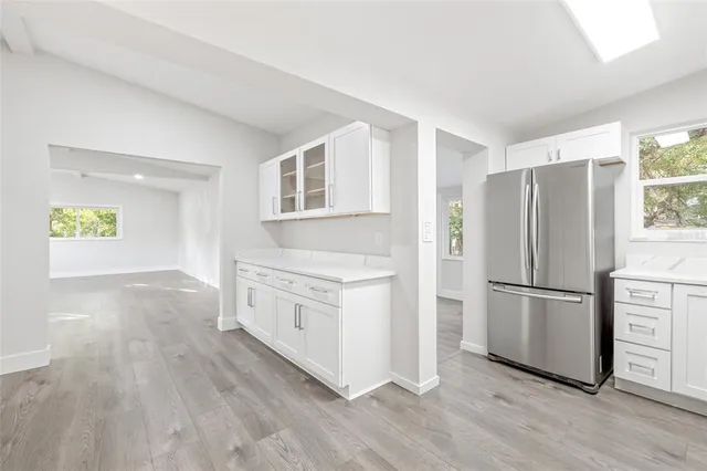 a kitchen with a refrigerator and a stove top oven