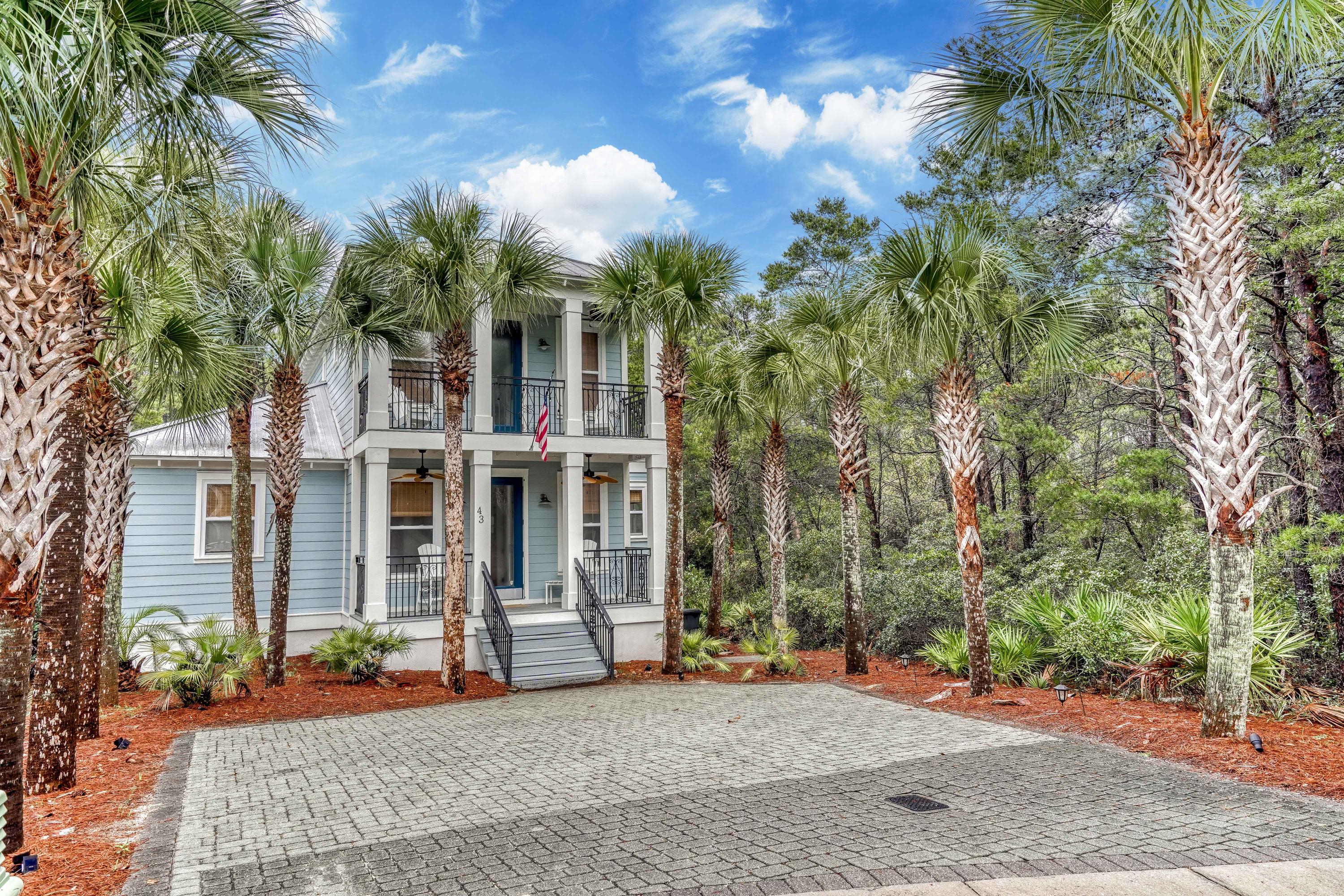 43 Lifeguard Loop East Inlet Beach, FL 32461 - Photo 3 of 44 a view of a brick house with large windows and a tree