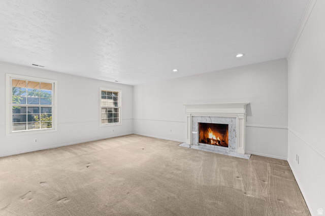 8441 Rua Branco Drive Sandy, UT 84093 - Photo 26 of 47 White marble fireplace with a classic mantel, recessed lighting, two double-hung windows, and light-toned carpeting