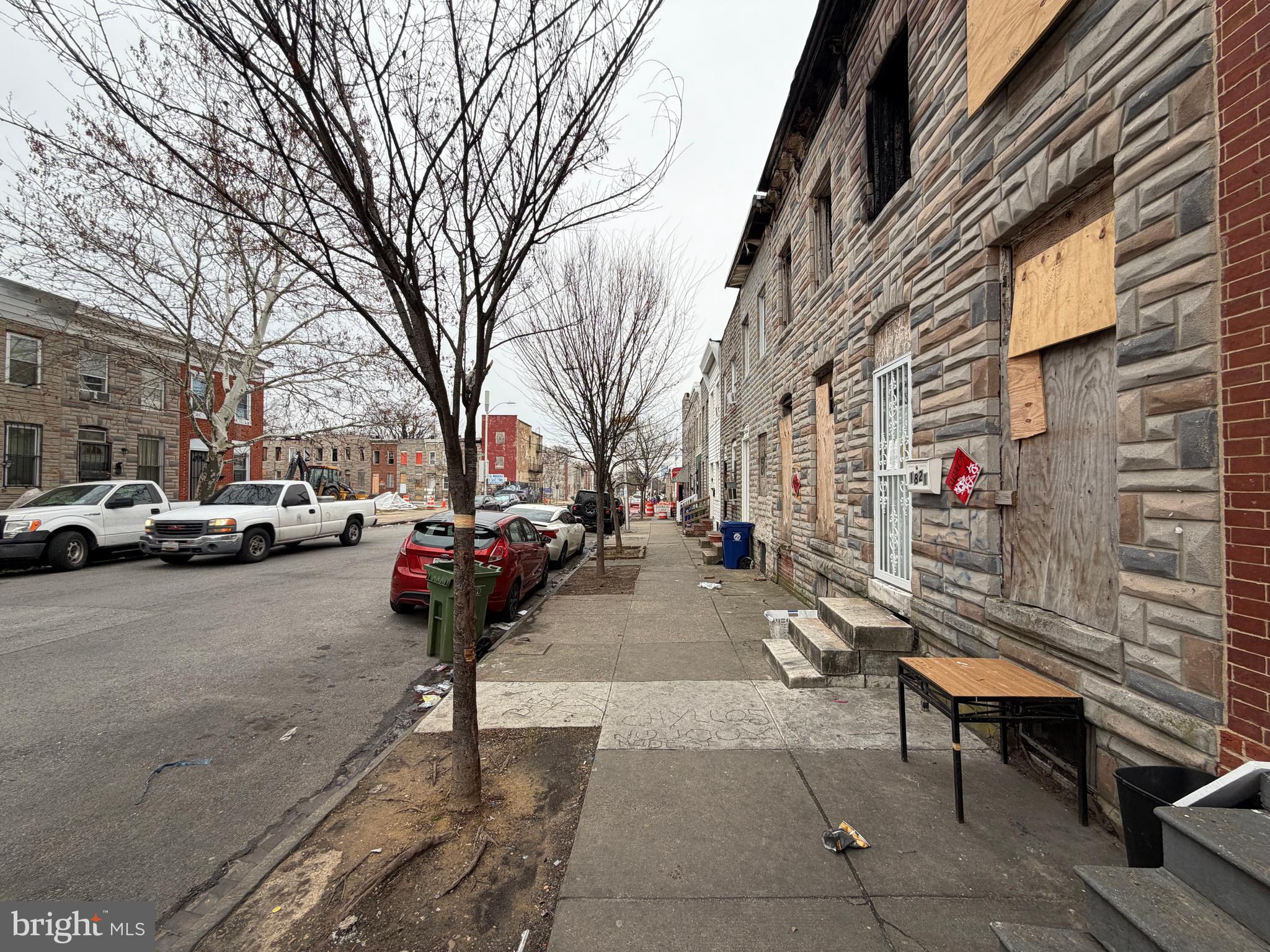 1821 Ramsay Street Baltimore, MD 21223 - Photo 2 of 6 a street with view of a building and car parked on the road