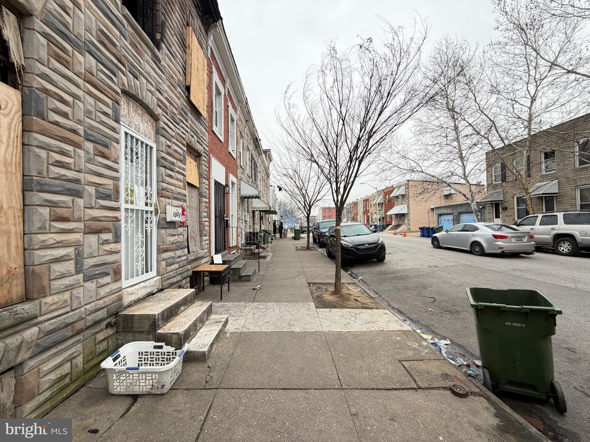 1821 Ramsay Street Baltimore, MD 21223 - Photo 3 of 6 a couple of cars parked in front of a building