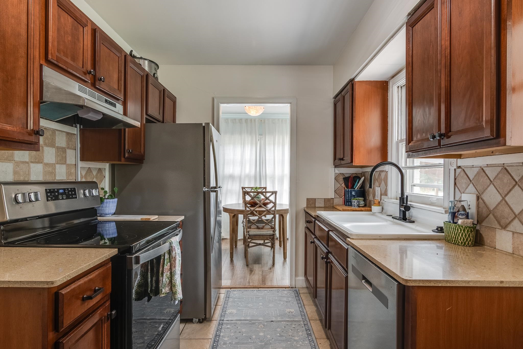 3901 Lytle Circle Memphis, TN 38122 - Photo 18 of 36 a kitchen with stainless steel appliances granite countertop a sink stove and refrigerator