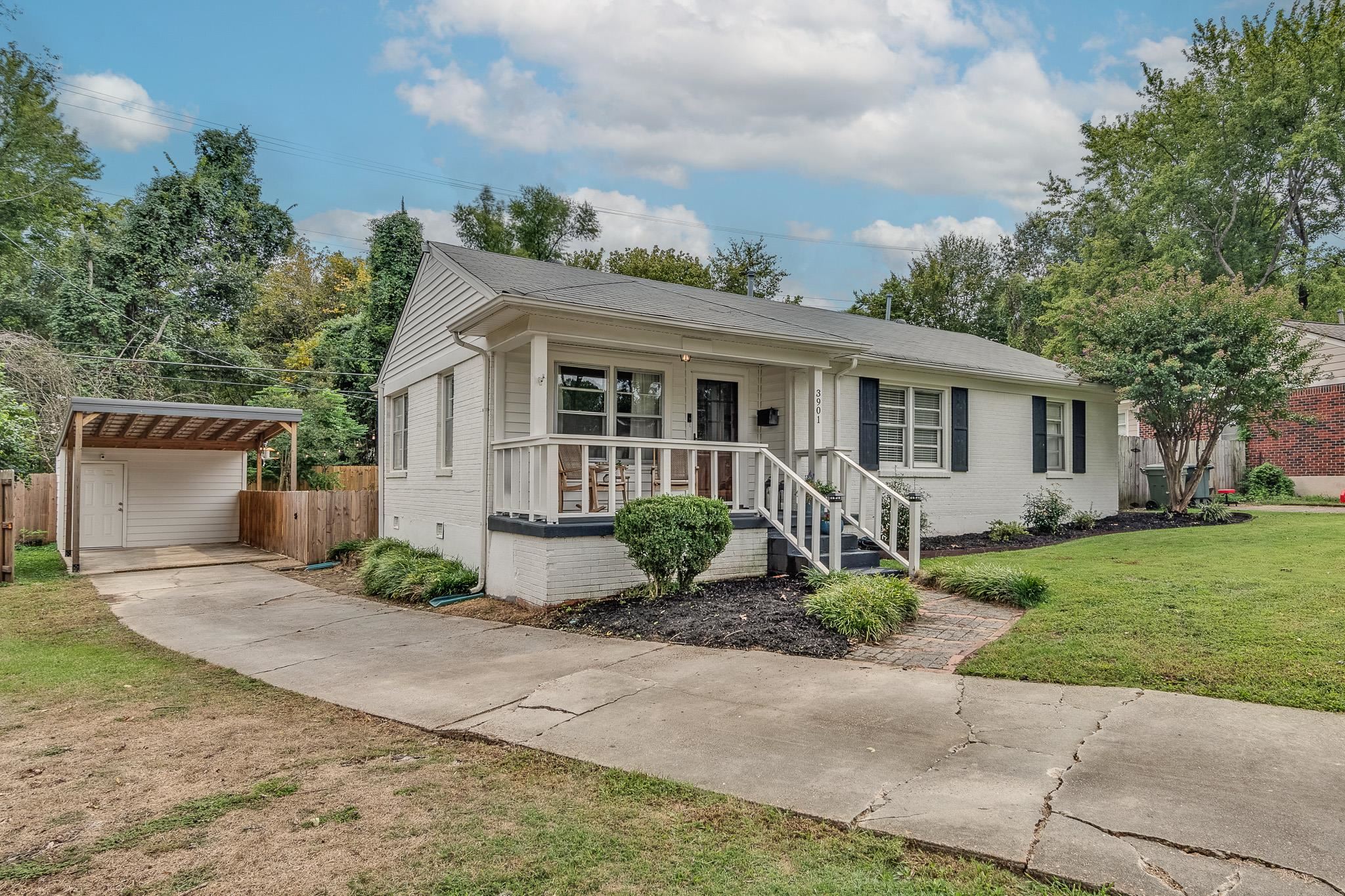 3901 Lytle Circle Memphis, TN 38122 - Photo 2 of 36 a view of a house with a yard and table and chairs under an umbrella