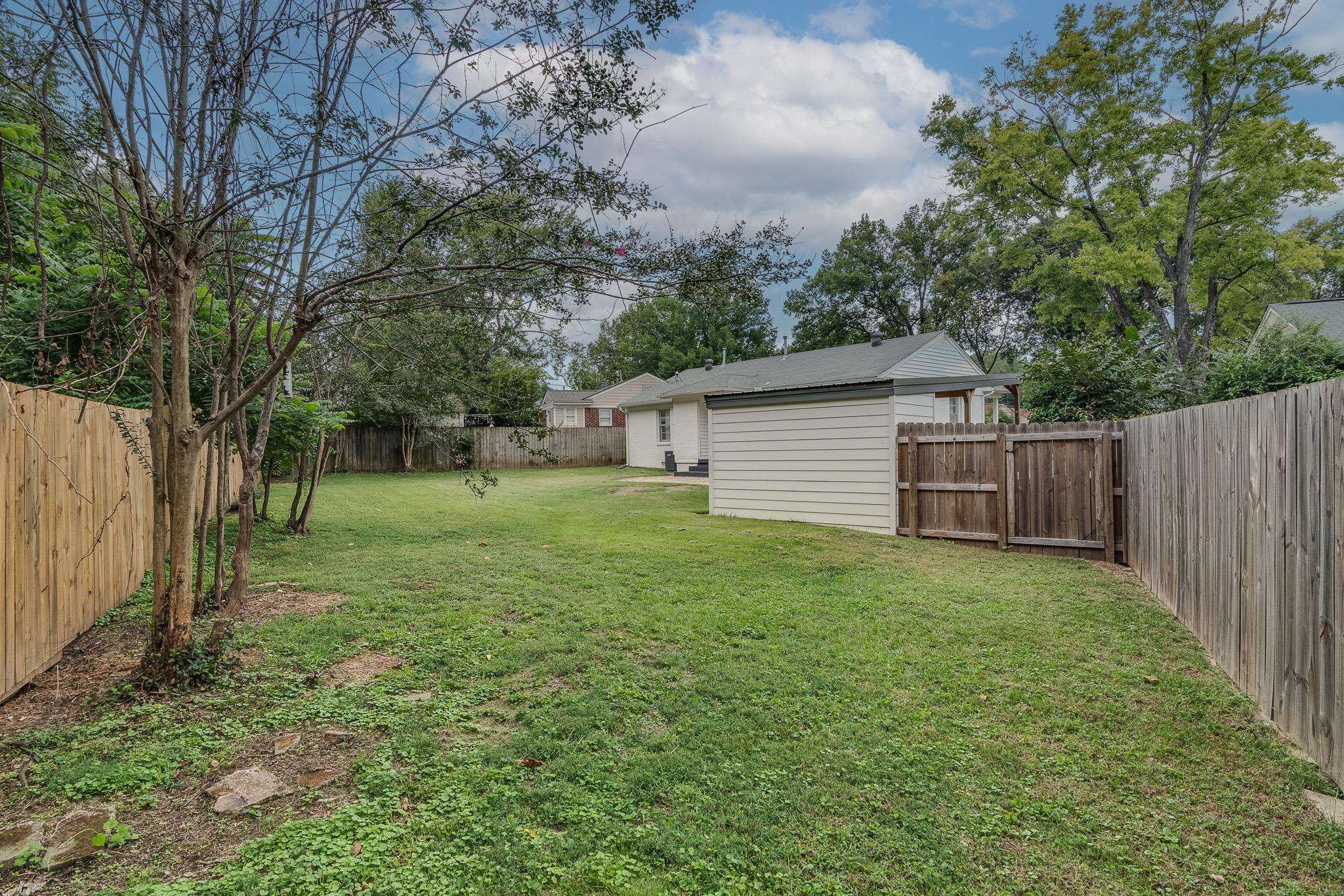 3901 Lytle Circle Memphis, TN 38122 - Photo 31 of 36 a view of a backyard with large trees and wooden fence