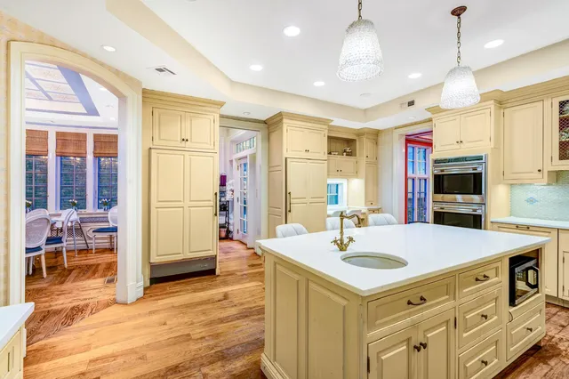 a bathroom with a granite countertop sink a mirror and shower