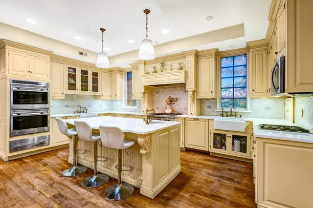 a bathroom with a granite countertop sink a toilet and shower